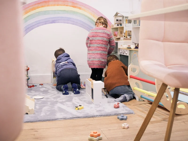 Parents enjoying coffee while children play safely