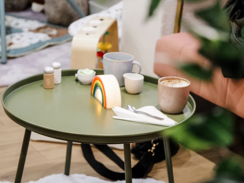 Parents enjoying coffee while children play safely